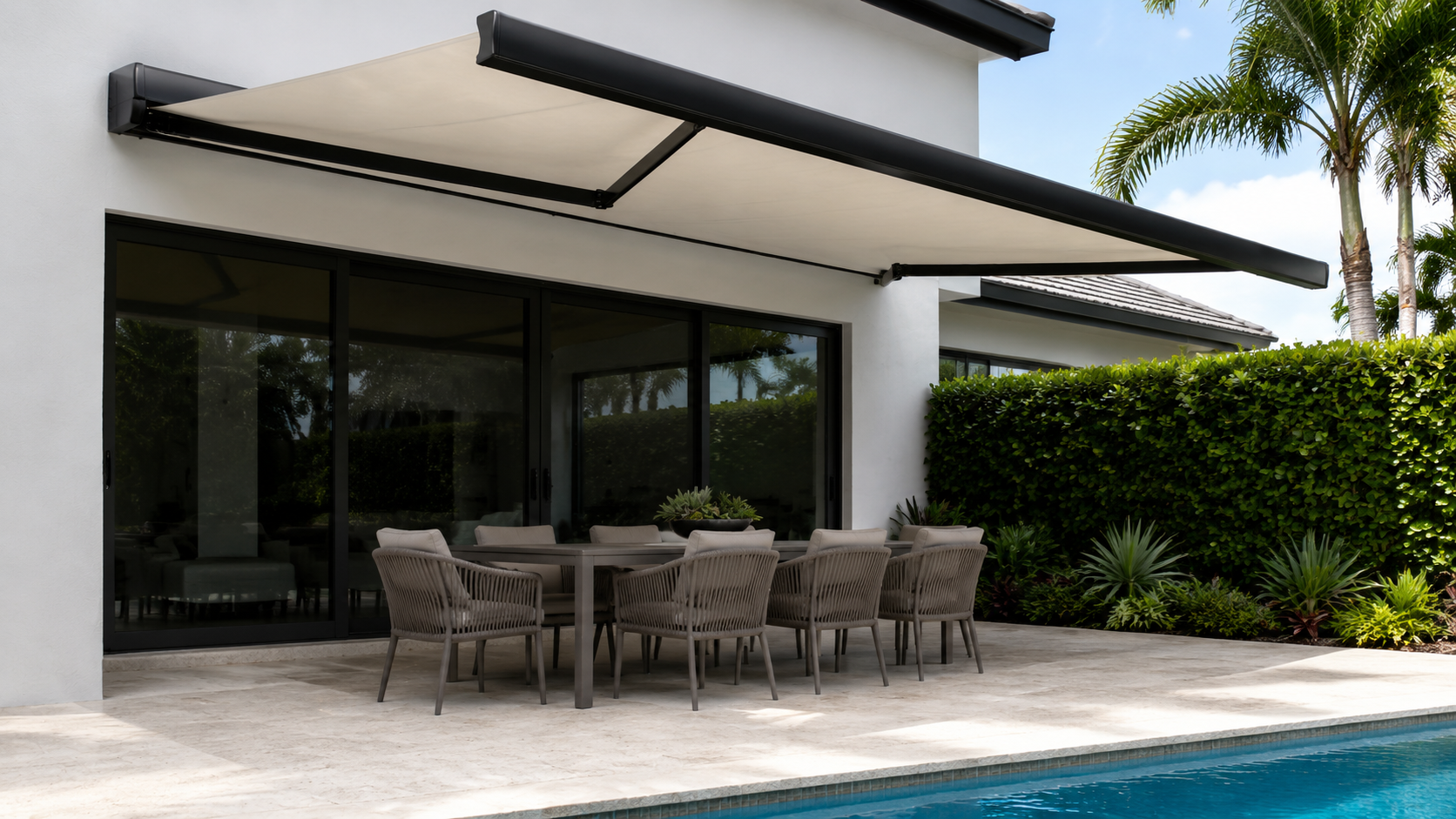 Black full-cassette awning with solid linen fabric over a modern Palm Beach pool terrace